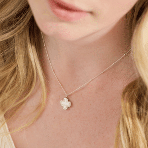 Model wearing Clover Breastmilk Necklace on satellite chain – handmade breastmilk jewellery keepsake with four-leaf clover charm.