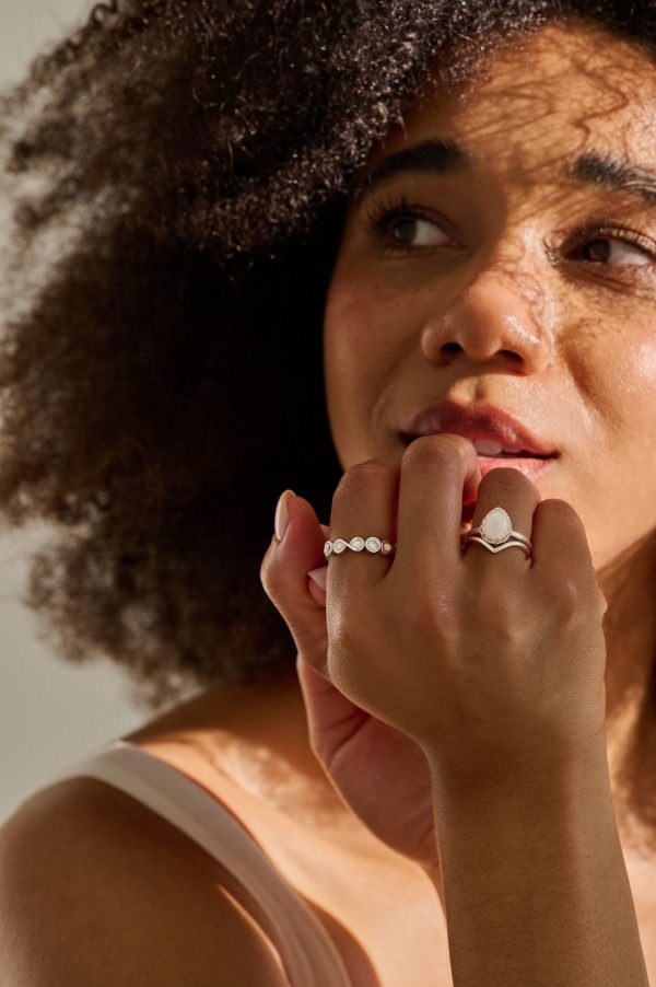 Model showcasing Breastmilk Crown Teardrop Ring, Wishbone Stacking Ring and Infinity Breastmilk Ring - breastfeeding keepsakes.